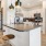 a kitchen with a bar stool and a bar stool