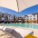 a pool with chairs and umbrella