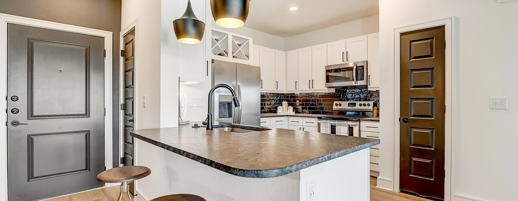 a kitchen with a bar stool and a bar stool